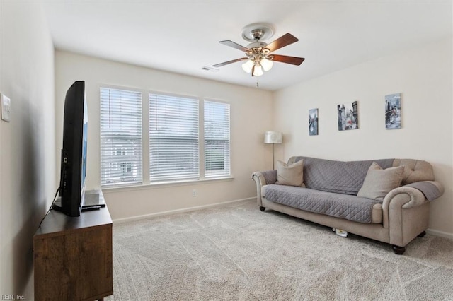 living area with a ceiling fan, carpet, visible vents, and baseboards