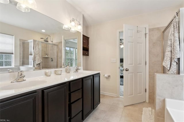 ensuite bathroom featuring a tub to relax in, tiled shower, double vanity, a sink, and tile patterned floors