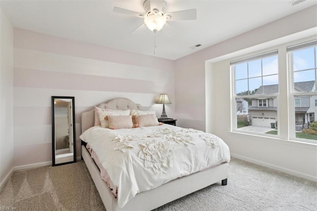 bedroom featuring ceiling fan, carpet, visible vents, and baseboards