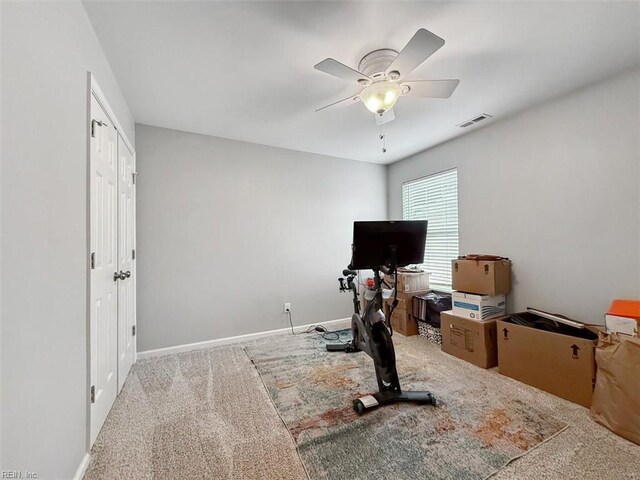 exercise room with visible vents, baseboards, a ceiling fan, and carpet floors