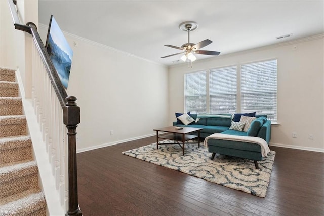 living area with visible vents, wood finished floors, ceiling fan, and crown molding