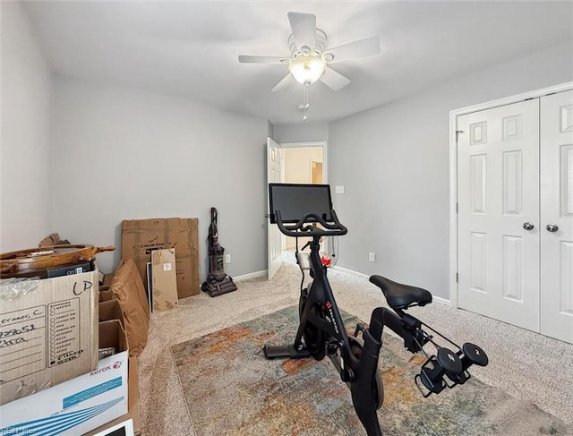 workout room with baseboards, carpet, and a ceiling fan