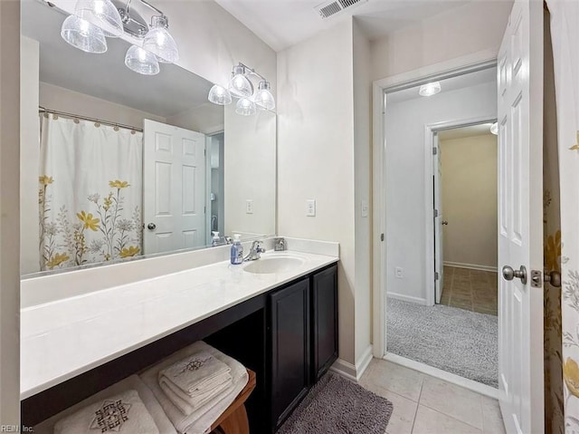 bathroom featuring tile patterned floors, visible vents, vanity, and baseboards