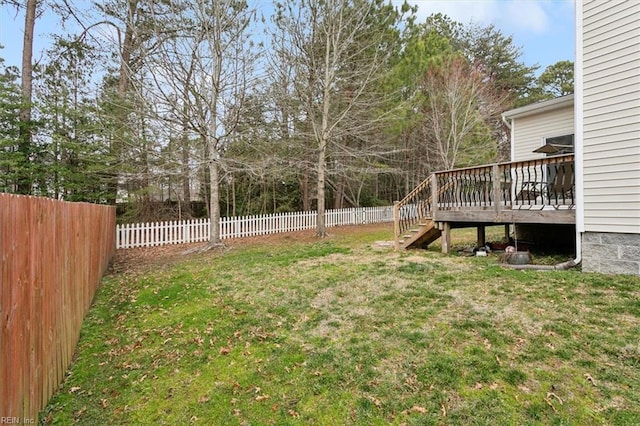 view of yard with stairway, a fenced backyard, and a wooden deck