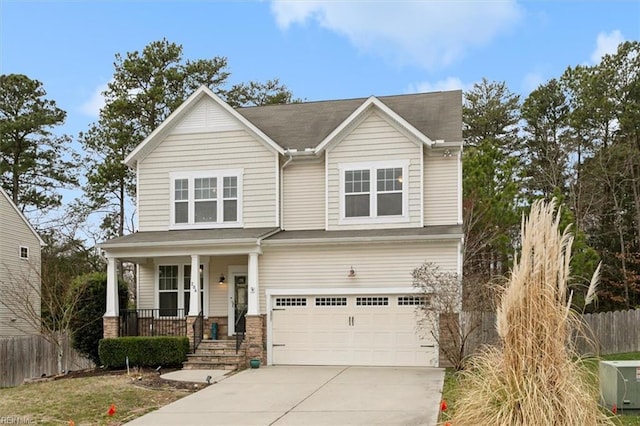 view of front of home with covered porch, driveway, an attached garage, and fence