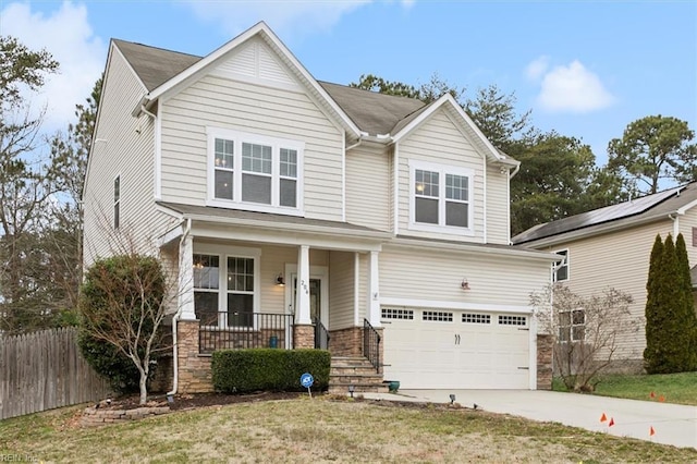 view of front of house with fence, concrete driveway, covered porch, a garage, and stone siding