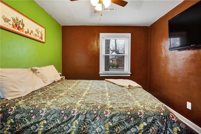 bedroom featuring visible vents, baseboards, and ceiling fan