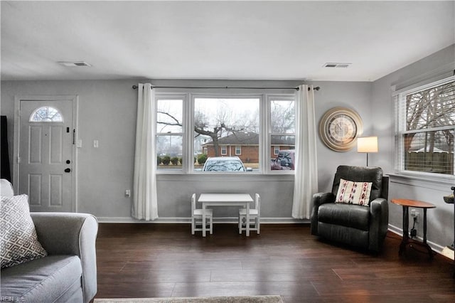 interior space featuring wood finished floors, visible vents, and baseboards