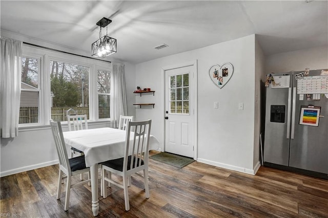 dining room with visible vents, baseboards, and dark wood finished floors