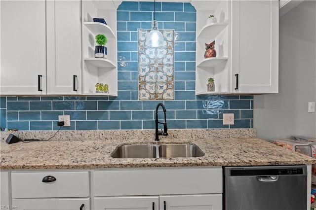 kitchen with tasteful backsplash, open shelves, stainless steel dishwasher, white cabinetry, and a sink