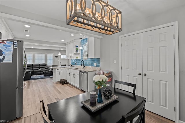 dining room featuring recessed lighting, visible vents, and light wood-style flooring