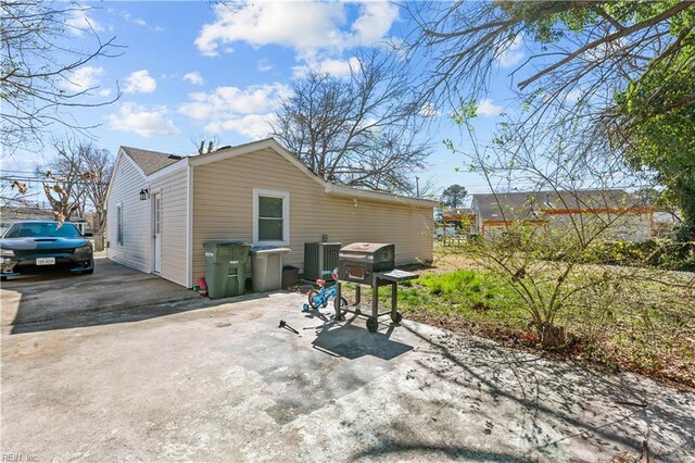 rear view of house with a patio and cooling unit