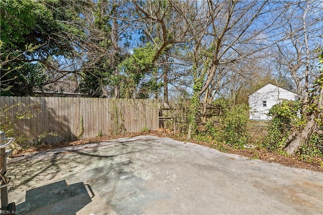 view of patio / terrace featuring an outbuilding and fence