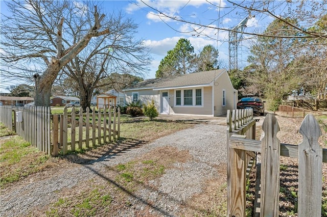 view of front of property with a fenced front yard and driveway