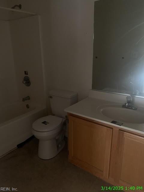 bathroom featuring toilet, vanity, and shower / tub combination