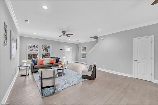 living room with baseboards, wood finished floors, visible vents, and ceiling fan