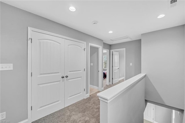 hallway with recessed lighting, baseboards, an upstairs landing, and carpet floors