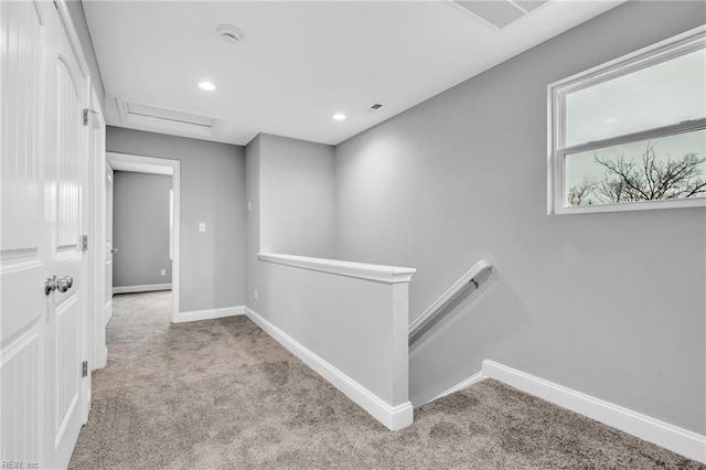 corridor with an upstairs landing, recessed lighting, carpet flooring, baseboards, and attic access