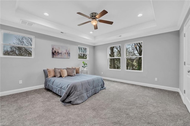 carpeted bedroom featuring baseboards, a raised ceiling, multiple windows, and visible vents