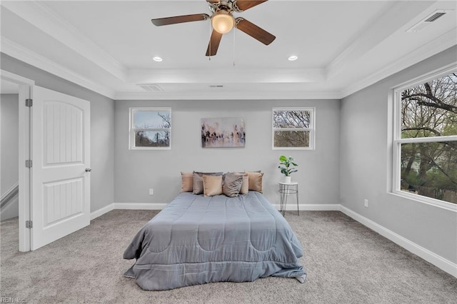 bedroom featuring a raised ceiling, multiple windows, visible vents, and carpet floors