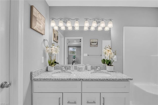 bathroom featuring double vanity and a sink