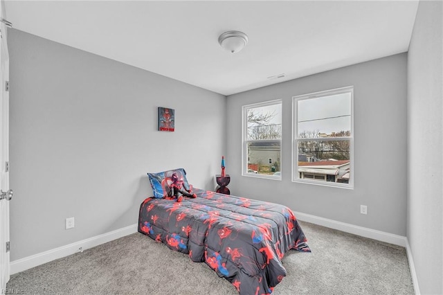 carpeted bedroom featuring baseboards