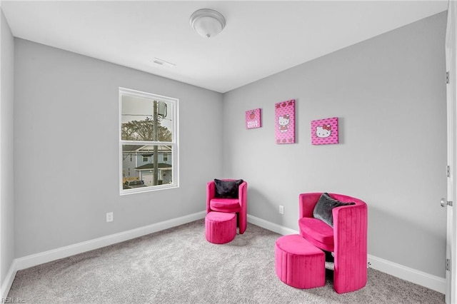 sitting room featuring visible vents, baseboards, and carpet flooring