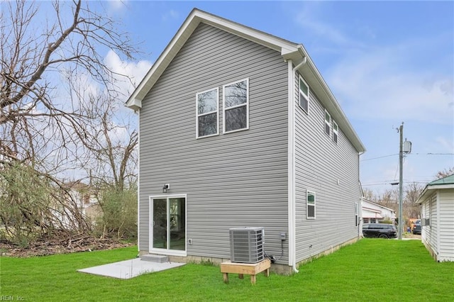 back of house featuring a yard, a patio, and central AC unit