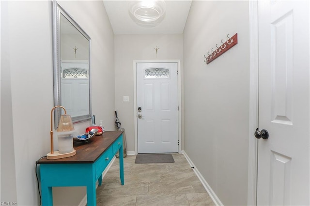 doorway to outside with baseboards