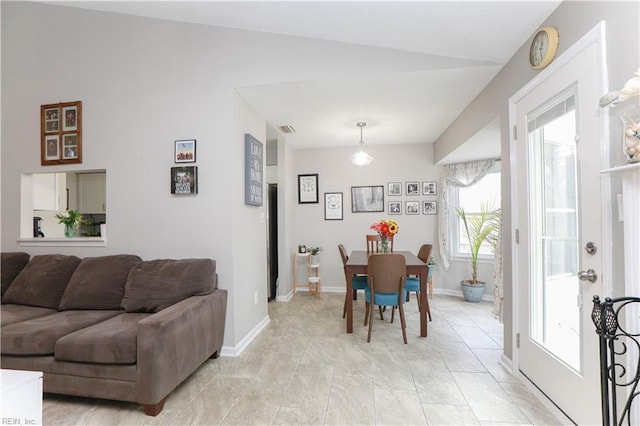 dining space featuring vaulted ceiling, visible vents, and baseboards