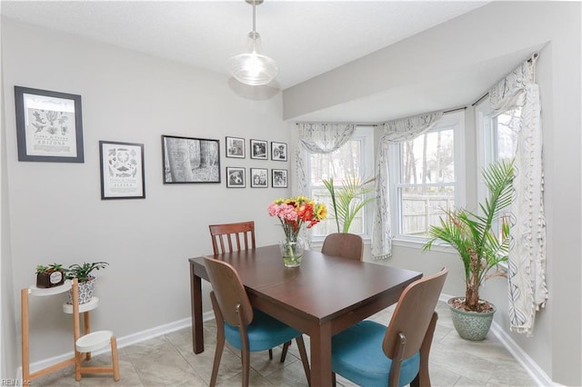 dining space featuring baseboards