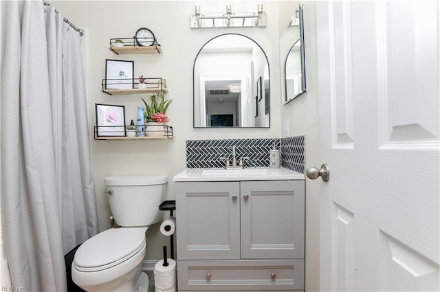 bathroom featuring toilet and vanity