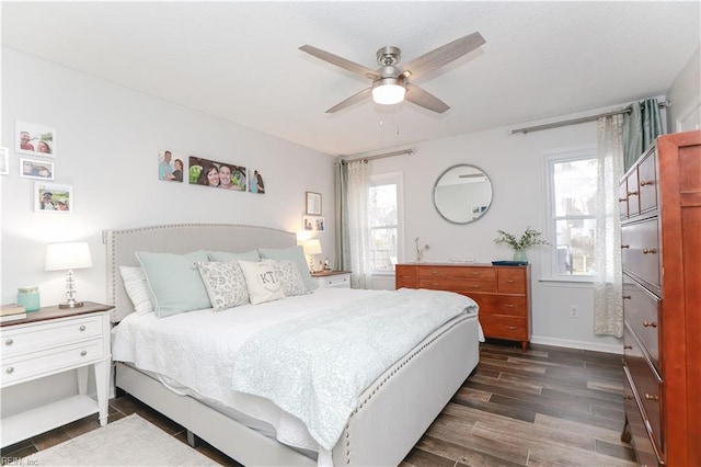 bedroom with baseboards, dark wood finished floors, and a ceiling fan