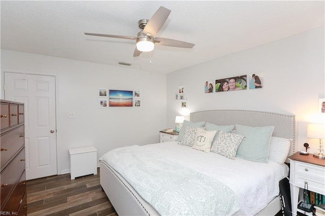 bedroom with visible vents, wood finished floors, and a ceiling fan