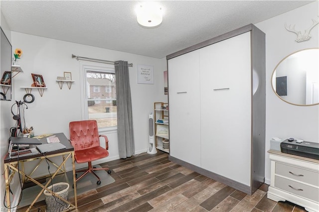 home office featuring baseboards, a textured ceiling, and wood finish floors