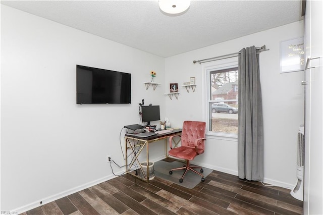 home office with dark wood-type flooring, baseboards, and a textured ceiling