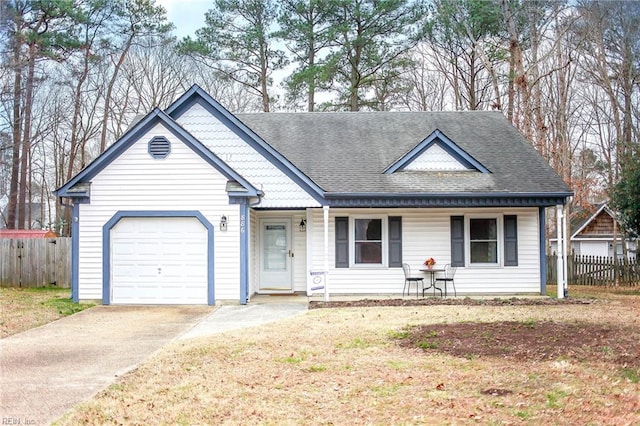 view of front facade with fence, roof with shingles, covered porch, concrete driveway, and an attached garage