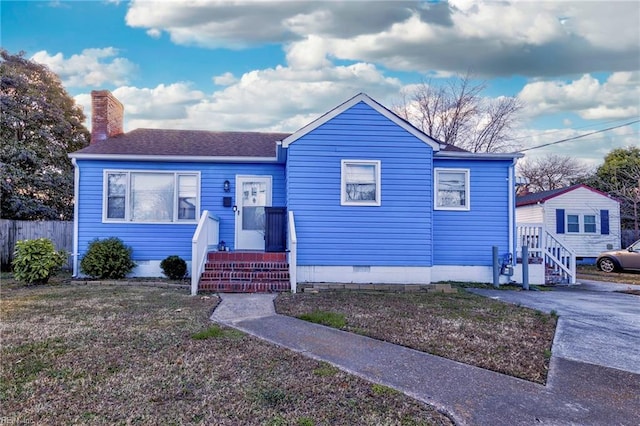 bungalow with a shingled roof, a chimney, a front yard, and fence