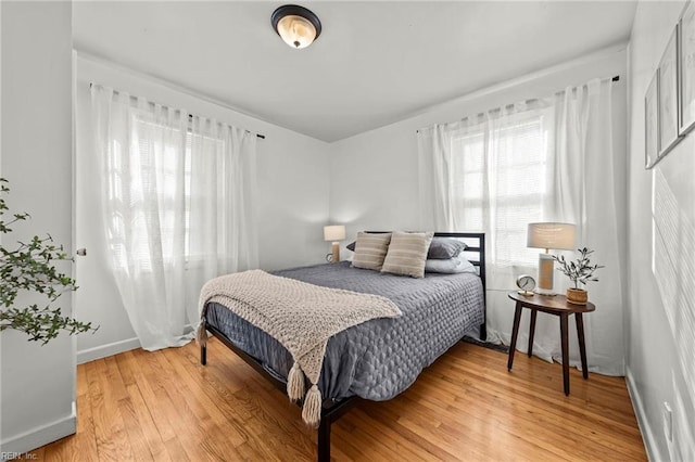 bedroom featuring baseboards and light wood-style floors