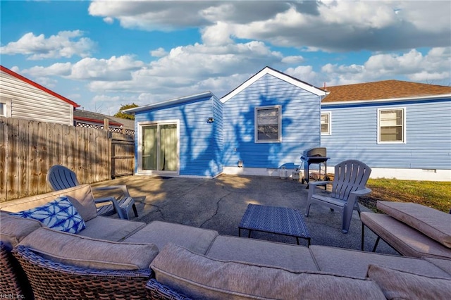 back of house featuring a patio, fence, and an outdoor living space