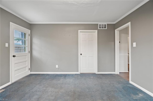 carpeted empty room with visible vents, baseboards, and ornamental molding