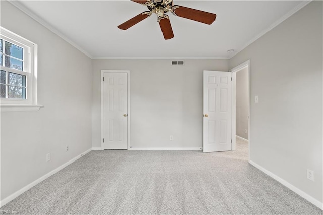 unfurnished bedroom with carpet flooring, baseboards, and ornamental molding