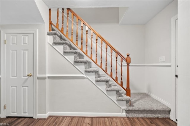 stairs featuring baseboards and wood finished floors