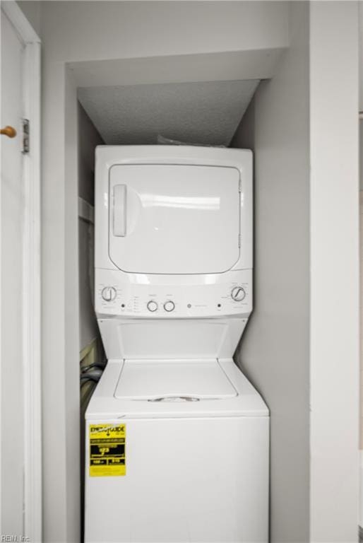 laundry room featuring stacked washer and clothes dryer and laundry area