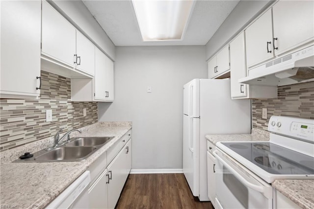 kitchen with under cabinet range hood, light countertops, white cabinets, white appliances, and a sink