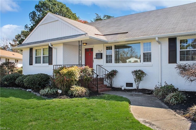 view of front of property with covered porch and a front yard