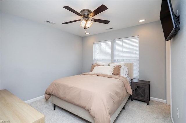 carpeted bedroom featuring visible vents, a ceiling fan, and baseboards