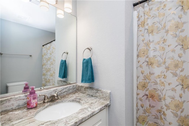 full bath with toilet and vanity