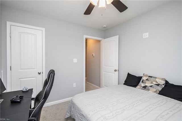 carpeted bedroom featuring baseboards and a ceiling fan