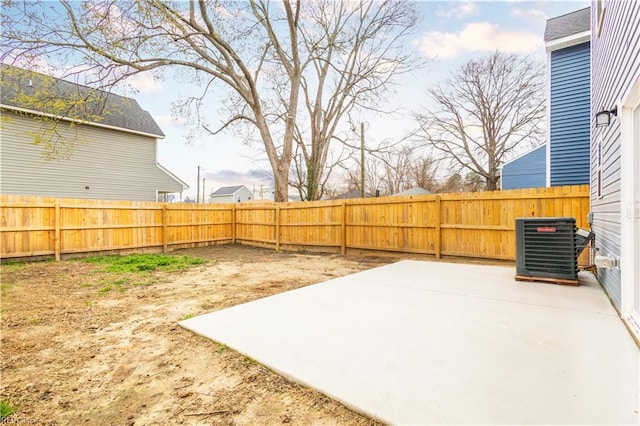 view of yard with cooling unit, a fenced backyard, and a patio